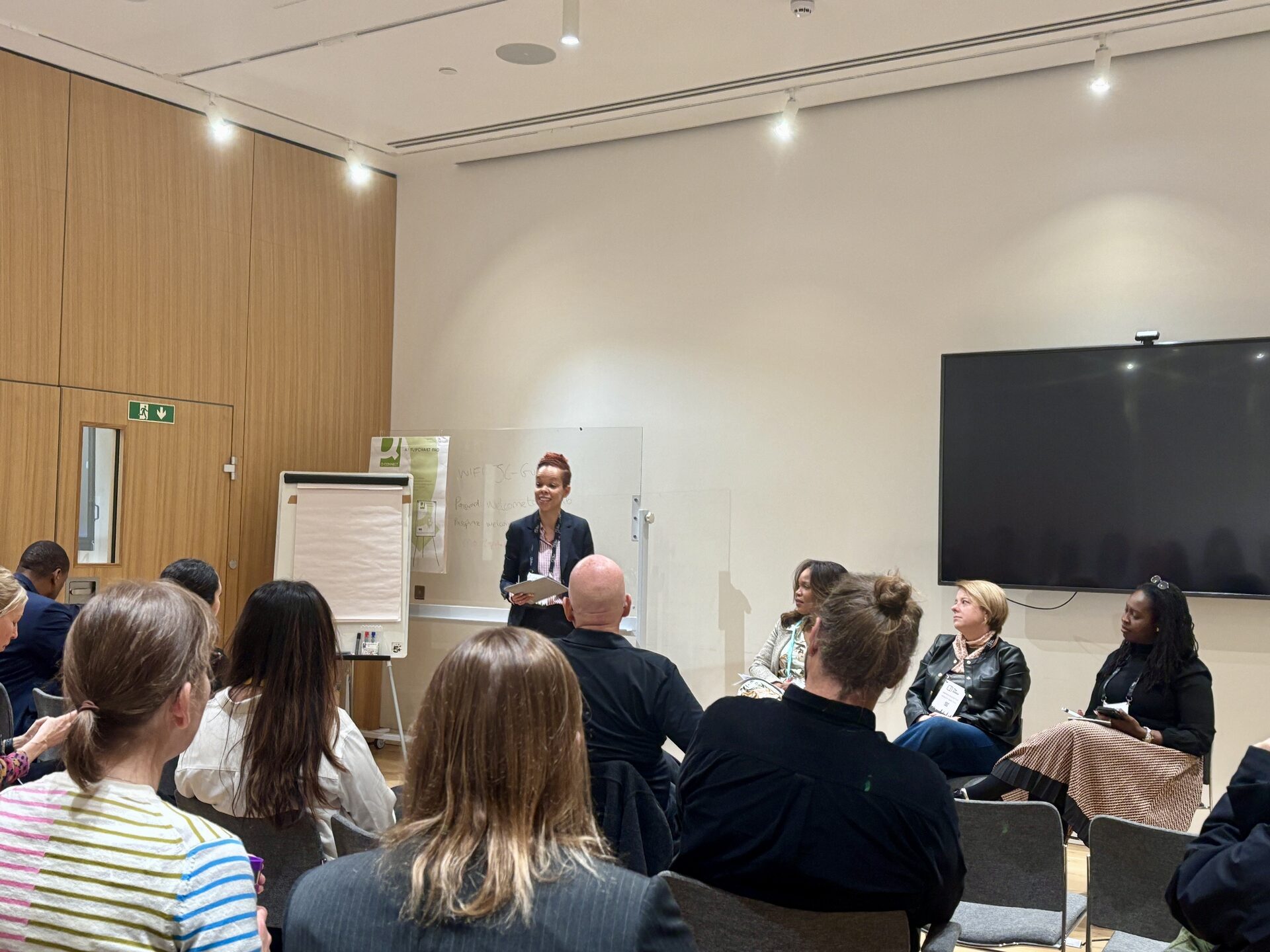 A strategy session in progress, facilitator presenting to a seated group